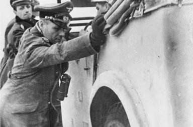 Erwin Rommel helps to push his stuck staff car somewhere in Northern Africa, 1941