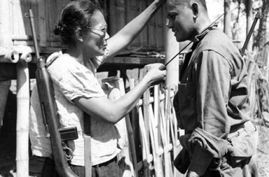 Captain Nieves Fernandez shows to an American soldier how she used her long knife to silently kill Japanese soldiers during occupation, 1944.