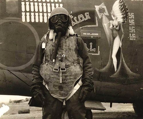 An-airgunner-stands-before-his-B-24-bomb
