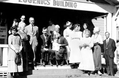 Winning family of the Fittest Family award stand outside of the Eugenics Building, 1925