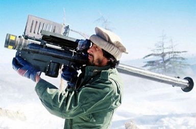 A Mujahideen fighter aims an FIM-92 Stinger missile at passing aircraft, Afghanistan, 1988