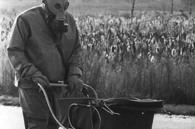 A Chernobyl liquidator pushes a baby in a carriage who was found during the cleanup of the Chernobyl nuclear accident, 1986