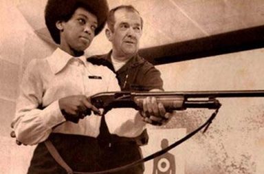 Saundra Brown, the first black woman on the Oakland police force, gets instructions on how to shoot a shotgun, 1970
