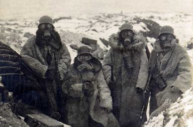Four German soldiers wearing fur coats and gas masks in a trench, 1917