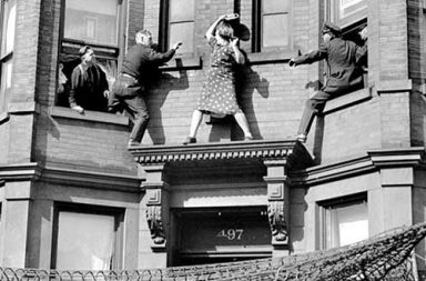 A lady battles with police as they try to prevent her from committing suicide, 1942