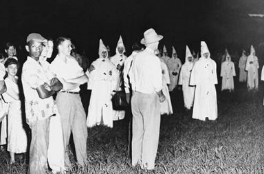 A lone African-American man attends a Klan rally in Jackson, USA, 1950