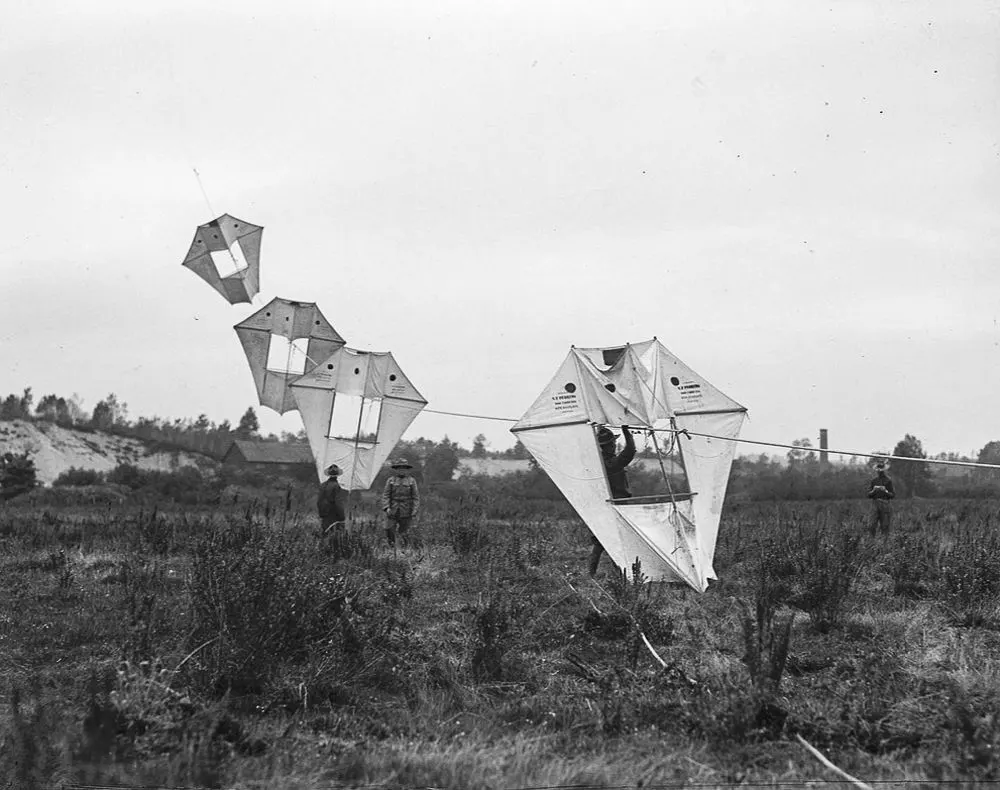 Vintage man lifting kites 
