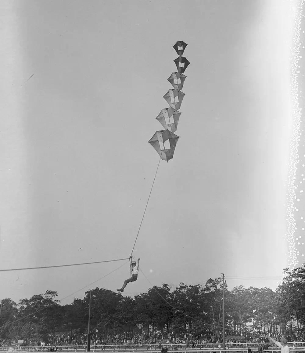 Vintage man lifting kites 